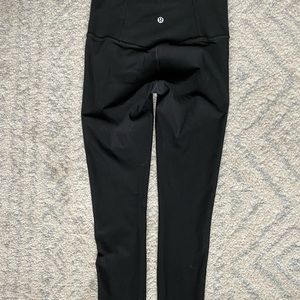 Lulu lemon high rise black leggings with laser cut mesh detail on sides.